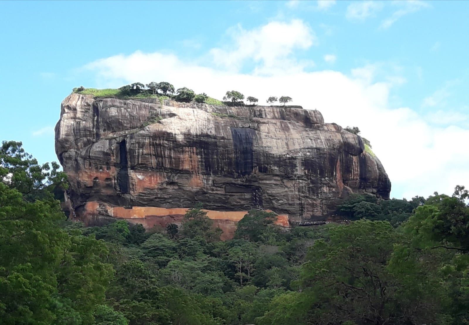 The rock fortress of Sigiriya rising above the surrounding forest, Sri Lanka.