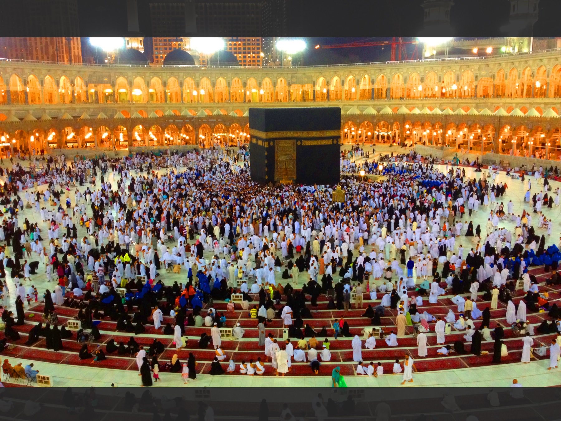 Pilgrims performing tawaf around the Kaaba at Masjid al-Haram late at night.