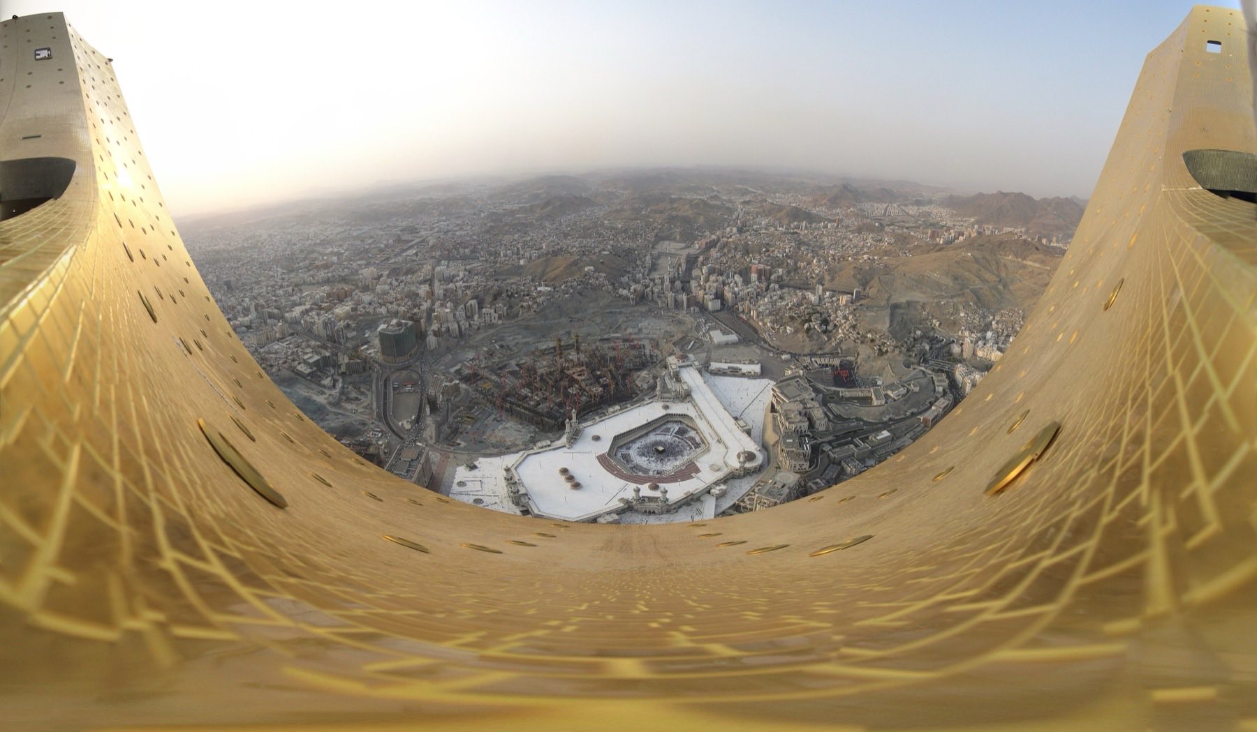 Makkah at night from above, the Haram lit at the centre.